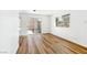 Spacious living space featuring wood-look floors and a glass sliding door to the exterior at 5078 Mountain Vista St, Las Vegas, NV 89120