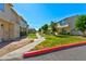 A nice complex of multiple level townhomes with grass and trees between the units at 5078 Mountain Vista St, Las Vegas, NV 89120