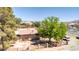 Aerial view of the property featuring a house with brick exterior and large trees at 5262 Harris Ave, Las Vegas, NV 89110