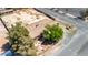 Aerial view of a single-story home with a brown roof and mature trees surrounding it at 5262 Harris Ave, Las Vegas, NV 89110