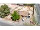 Aerial view of a house with mature trees, a white car, and a truck parked in front at 5262 Harris Ave, Las Vegas, NV 89110