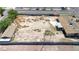 Aerial view of large vacant lot next to a building and street with sparse desert landscaping at 5262 Harris Ave, Las Vegas, NV 89110