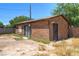 This backyard features a small outbuilding, desert landscaping, and a concrete block fence at 5262 Harris Ave, Las Vegas, NV 89110