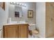 Cozy bathroom featuring a single sink vanity, toilet, and tiled shower with neutral-toned wall coverings at 5262 Harris Ave, Las Vegas, NV 89110