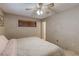 Bedroom with wallpaper, window, carpet flooring, and neutral colored bedding at 5262 Harris Ave, Las Vegas, NV 89110