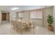 Bright dining room with seating for ten, and large windows provide ample natural light at 5262 Harris Ave, Las Vegas, NV 89110