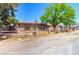 Cozy single-story home with wooden fence, set in a large lot with shade tree and mature trees at 5262 Harris Ave, Las Vegas, NV 89110
