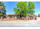Charming single-story home with a rustic wooden fence and mature shade tree in front yard at 5262 Harris Ave, Las Vegas, NV 89110