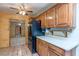 Kitchen boasts wood cabinets, black appliances, white countertops, tile floors, and a breakfast bar at 5262 Harris Ave, Las Vegas, NV 89110