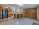 Vintage eat-in kitchen featuring wooden cabinets, tile floors, and black appliances in a well-lit space at 5262 Harris Ave, Las Vegas, NV 89110