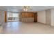 Expansive living area features tile floors, a wood panel accent wall, and a view into the dining room at 5262 Harris Ave, Las Vegas, NV 89110