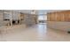 Cozy living room with a brick fireplace, tile flooring, and seamless access to the dining area at 5262 Harris Ave, Las Vegas, NV 89110