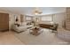 Virtually staged living room with neutral tones, modern furniture, and lots of natural light at 5262 Harris Ave, Las Vegas, NV 89110