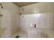 A spacious tile shower with shower head and handheld, plus a tiled bench at 5262 Harris Ave, Las Vegas, NV 89110