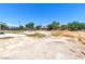 A landscape view of the property showing the mostly bare ground and the exterior of the outbuilding at 5262 Harris Ave, Las Vegas, NV 89110