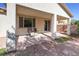 Covered backyard patio with seating, overlooking gravel landscaping and a block wall at 5412 Dalle Valley St, North Las Vegas, NV 89031