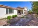 Spacious backyard with covered patio, gravel landscaping, and mature trees at 5412 Dalle Valley St, North Las Vegas, NV 89031