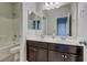 Bathroom features a double sink vanity with dark wood cabinets and a tub/shower combo at 5412 Dalle Valley St, North Las Vegas, NV 89031