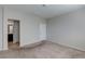 Bedroom with neutral carpet, white trim, and a view to an attached bathroom at 5412 Dalle Valley St, North Las Vegas, NV 89031