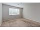 Light-filled bedroom with neutral carpet and a large window providing natural light at 5412 Dalle Valley St, North Las Vegas, NV 89031
