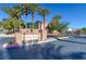 The Geyser Peak community sign stands proudly at the entrance with palm trees, plants, and greenery around the area at 5412 Dalle Valley St, North Las Vegas, NV 89031