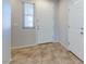 Entryway featuring light gray walls, tile flooring and two white doors at 5412 Dalle Valley St, North Las Vegas, NV 89031