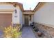 Close-up of the home's entrance, showcasing a brick pathway, desert landscaping, and exterior stone accents at 5412 Dalle Valley St, North Las Vegas, NV 89031
