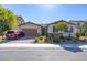 Charming single-Gathering home featuring a two-car garage, desert landscaping, and a red car in the driveway at 5412 Dalle Valley St, North Las Vegas, NV 89031