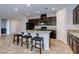 Gorgeous kitchen with granite countertops, dark wood cabinets, stainless appliances and a breakfast bar at 5412 Dalle Valley St, North Las Vegas, NV 89031