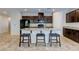 Kitchen features granite countertops, dark cabinets, a kitchen island and stainless steel appliances at 5412 Dalle Valley St, North Las Vegas, NV 89031