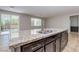 Close up of the kitchen island with granite countertops and stainless steel sink and dishwasher overlooking the backyard at 5412 Dalle Valley St, North Las Vegas, NV 89031