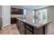 Kitchen island features stainless steel dishwasher, granite countertops and dark cabinets at 5412 Dalle Valley St, North Las Vegas, NV 89031
