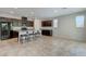 Open kitchen features dark cabinetry, granite counters, stainless appliances, and an island with bar stool seating at 5412 Dalle Valley St, North Las Vegas, NV 89031