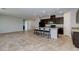 Spacious kitchen with granite countertops, dark cabinetry, an island with seating, and stainless steel appliances at 5412 Dalle Valley St, North Las Vegas, NV 89031