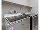 Modern laundry room features a Maytag Bravos XL washer and dryer, plus convenient overhead shelving at 5412 Dalle Valley St, North Las Vegas, NV 89031