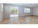 Open living room with tile flooring, bright natural light, and glass slider door that opens to the backyard at 5412 Dalle Valley St, North Las Vegas, NV 89031