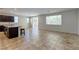 Open-concept living space with tile flooring, an eat-in kitchen, a window, and a sliding glass door at 5412 Dalle Valley St, North Las Vegas, NV 89031