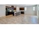 Open floor plan features tile floors, kitchen, breakfast bar, modern appliances, light gray walls and lots of light at 5412 Dalle Valley St, North Las Vegas, NV 89031