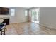 Living space with tile flooring, light gray walls, stainless steel appliances, and access to the backyard at 5412 Dalle Valley St, North Las Vegas, NV 89031