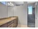 Modern bathroom featuring granite counters, a single sink, and a walk-in shower at 5852 Brown Tree Ln, North Las Vegas, NV 89081