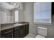 Bathroom features granite counters, neutral paint, and updated lighting at 5852 Brown Tree Ln, North Las Vegas, NV 89081