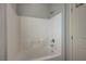 Clean, white tile bathtub and shower combination with chrome fixtures at 5852 Brown Tree Ln, North Las Vegas, NV 89081