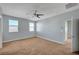Bright, airy bedroom with neutral walls, ceiling fan, and large windows, providing a serene atmosphere at 5852 Brown Tree Ln, North Las Vegas, NV 89081