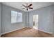 Comfortable bedroom with neutral walls, ceiling fan, and a window, offering a tranquil living space at 5852 Brown Tree Ln, North Las Vegas, NV 89081