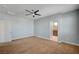 A carpeted bedroom with a ceiling fan and white trim, with an open doorway to the bathroom at 5852 Brown Tree Ln, North Las Vegas, NV 89081