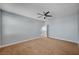 A carpeted bedroom with a ceiling fan, and an open doorway to other parts of the home at 5852 Brown Tree Ln, North Las Vegas, NV 89081