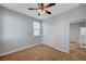 A carpeted bedroom with a closet, a window, and an open doorway to other parts of the home at 5852 Brown Tree Ln, North Las Vegas, NV 89081