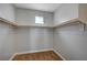 A walk-in closet with carpeted floors and shelving for optimal storage at 5852 Brown Tree Ln, North Las Vegas, NV 89081