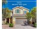 Charming two-story home featuring desert landscaping, a tile roof, and neutral-toned exterior paint at 5852 Brown Tree Ln, North Las Vegas, NV 89081