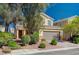 Front yard and facade of two-story residence with desert landscaping and covered entry at 5852 Brown Tree Ln, North Las Vegas, NV 89081
